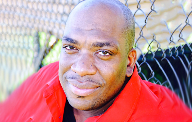 Jeff Wallace outside in front of a chainlink fence